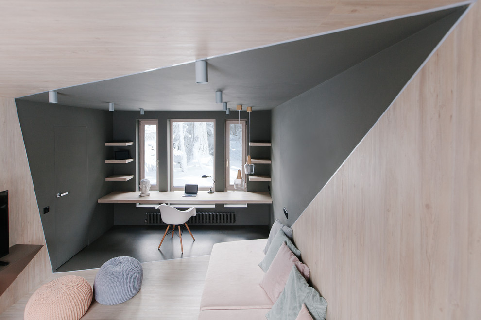 Photo of a contemporary study room in Moscow with grey walls, light hardwood floors, a built-in desk and grey floor.