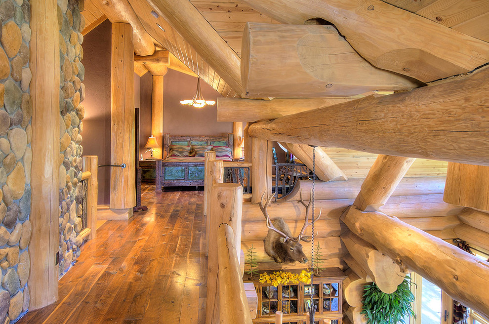 Example of a mid-sized mountain style medium tone wood floor and brown floor hallway design in Denver with brown walls