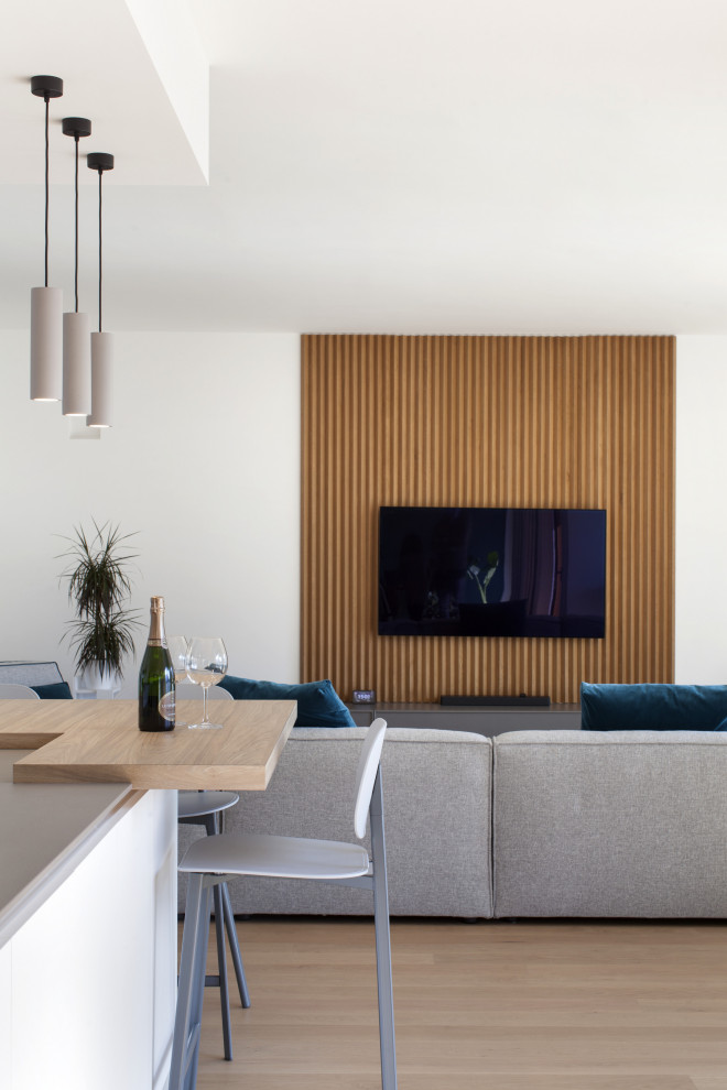 Inspiration for a large contemporary open concept family room in Milan with a wall-mounted tv and decorative wall panelling.