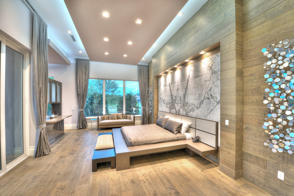Contemporary bedroom in Orlando with brown walls, medium hardwood floors and brown floor.