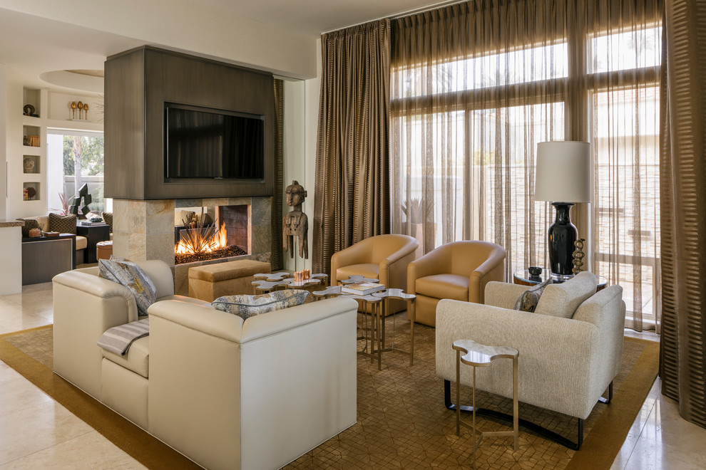 Design ideas for a mid-sized contemporary living room in Other with travertine floors, a two-sided fireplace, a stone fireplace surround, a wall-mounted tv, beige floor and beige walls.