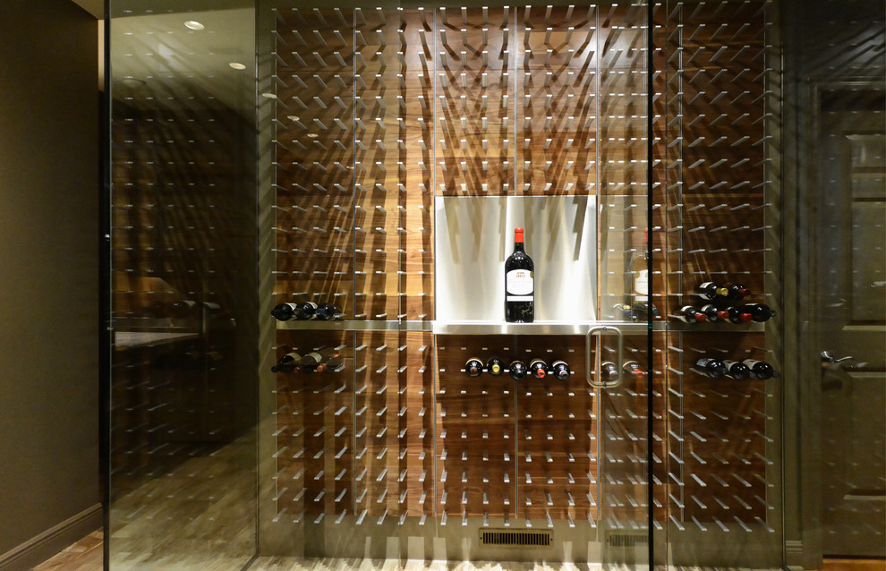 Large contemporary wine cellar in Tampa with light hardwood floors and storage racks.