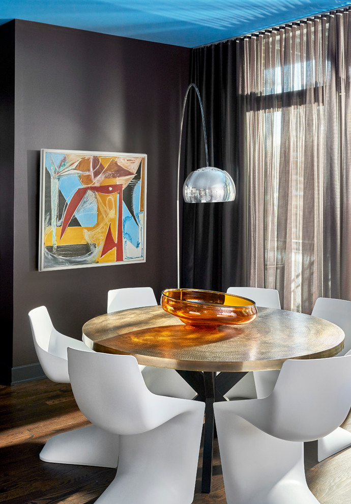 Photo of a mid-sized contemporary open plan dining in Chicago with dark hardwood floors, no fireplace and black walls.