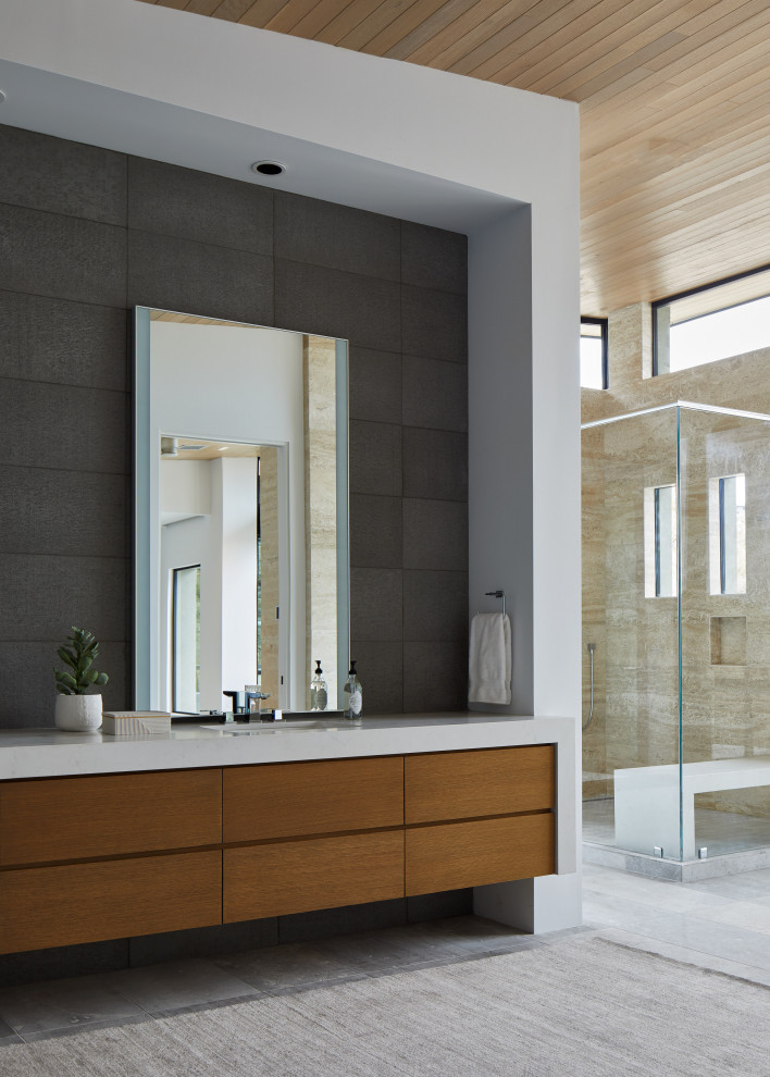 Expansive modern master bathroom in Phoenix with flat-panel cabinets, a freestanding tub, limestone floors, an undermount sink, quartzite benchtops, a double vanity, a floating vanity and wood.