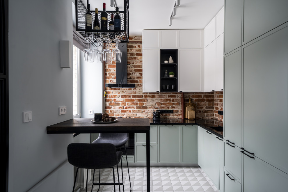 This is an example of a small contemporary l-shaped eat-in kitchen in Moscow with a single-bowl sink, turquoise cabinets, granite benchtops, orange splashback, brick splashback, black appliances, white floor and black benchtop.