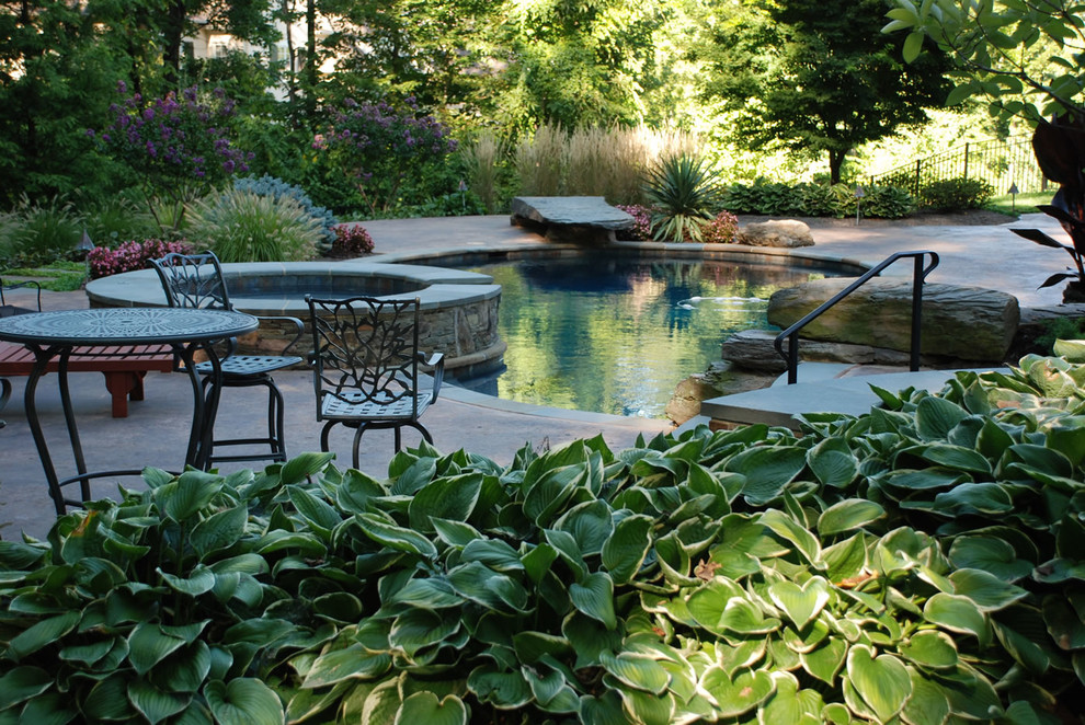 Large country backyard custom-shaped natural pool in New York with a hot tub and decomposed granite.