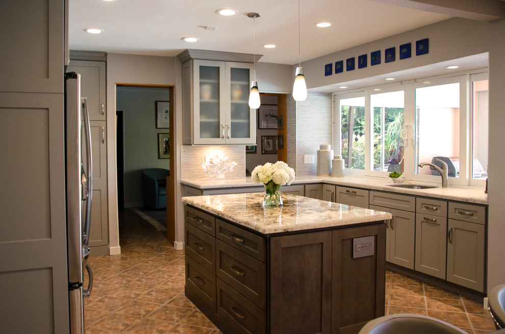 Example of a mid-sized transitional u-shaped open concept kitchen design in Miami with an undermount sink, shaker cabinets, gray cabinets, quartzite countertops, gray backsplash, porcelain backsplash, stainless steel appliances and an island