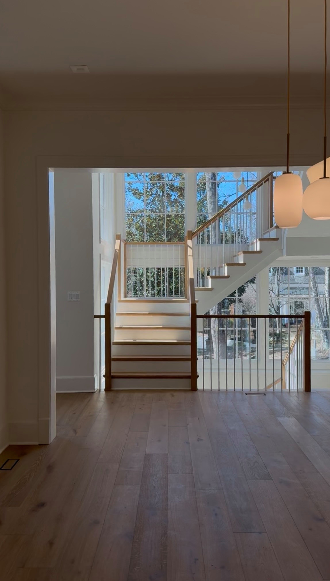 Project #152 | Three-Story White Oak Staircase with a Pendant Chandelier