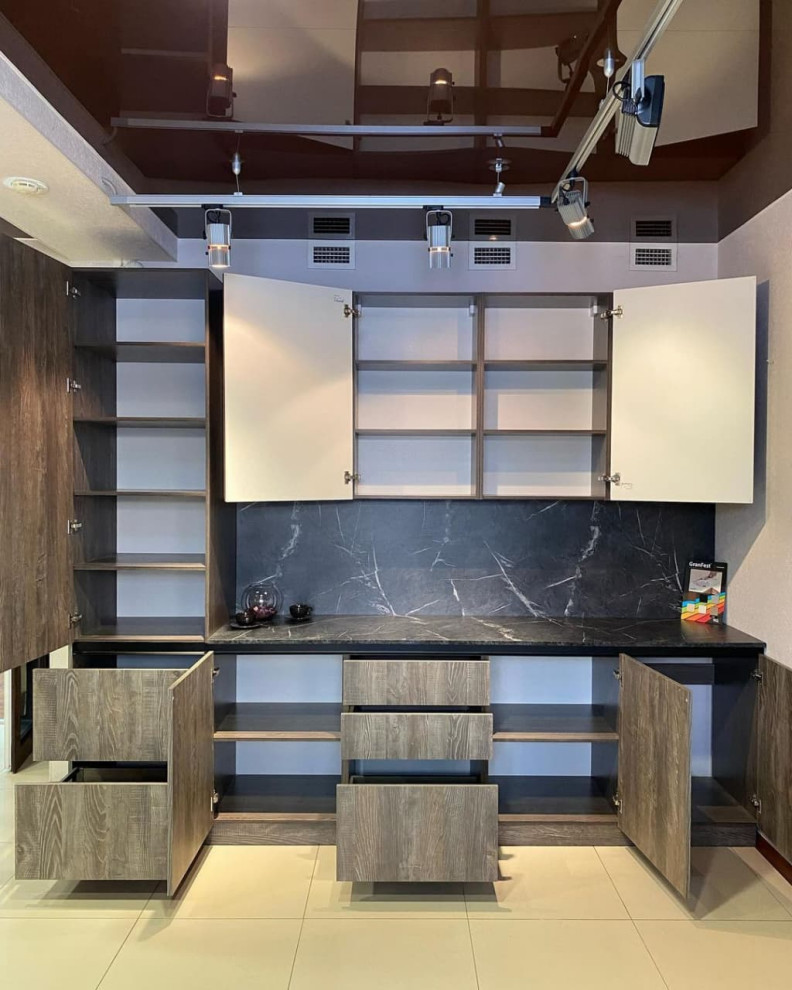 Design ideas for a medium sized industrial single-wall enclosed kitchen in Moscow with raised-panel cabinets, grey cabinets, granite worktops, black splashback, porcelain splashback, black appliances, ceramic flooring, no island, beige floors, black worktops and a vaulted ceiling.