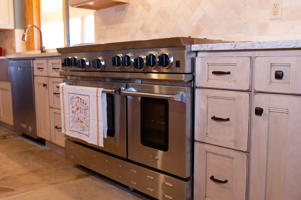 Mid-sized mountain style l-shaped beige floor enclosed kitchen photo in Denver with a farmhouse sink, medium tone wood cabinets, granite countertops, white backsplash, stainless steel appliances, an island and gray countertops