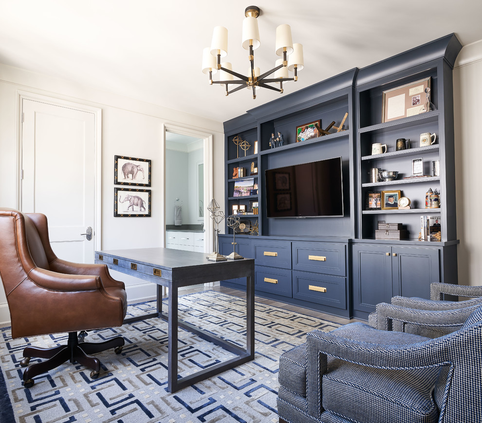 Example of a transitional freestanding desk medium tone wood floor and gray floor home office design in Charlotte with white walls