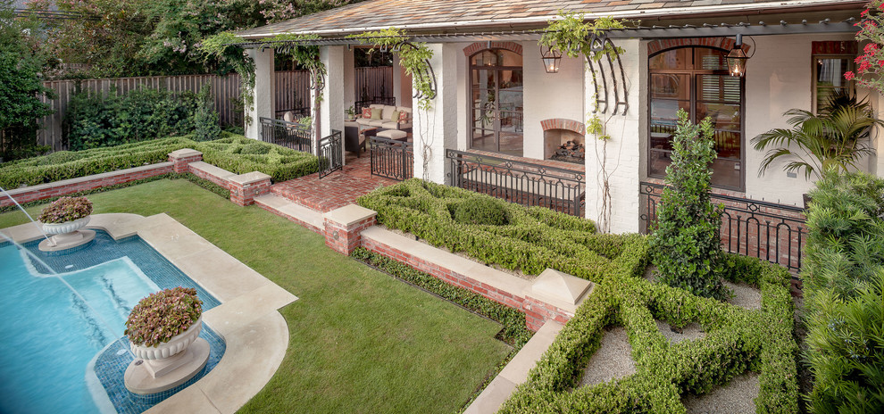 Inspiration for a large traditional backyard full sun garden in Houston with natural stone pavers.