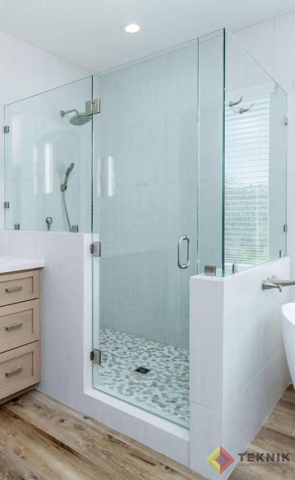 Inspiration for a large classic ensuite bathroom in San Diego with beige cabinets, a freestanding bath, a corner shower, a two-piece toilet, grey tiles, white walls, vinyl flooring, a submerged sink, engineered stone worktops, brown floors, white worktops, an enclosed toilet, a single sink, a built in vanity unit and wainscoting.