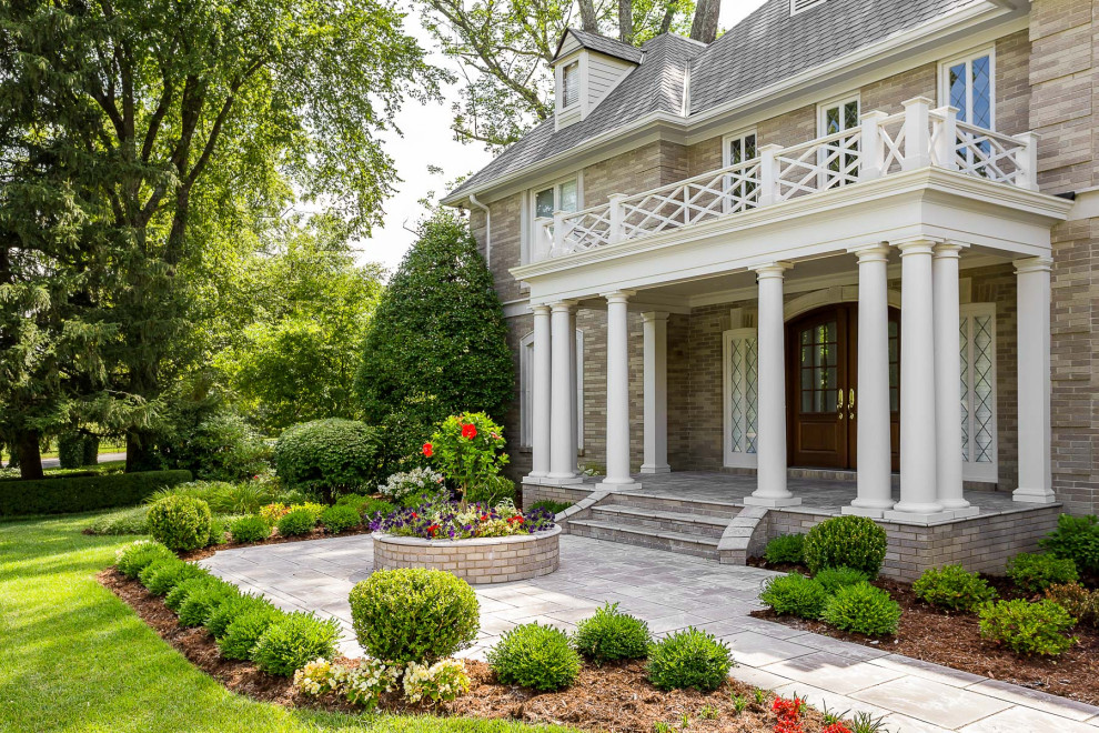 This is an example of a mid-sized traditional front yard garden in Louisville with concrete pavers.