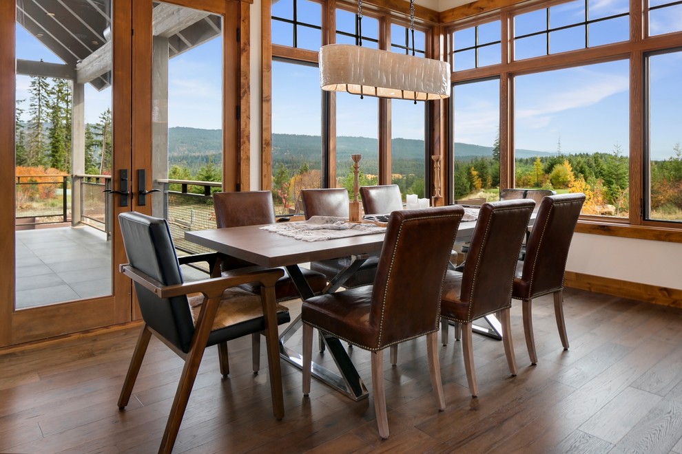Photo of a country dining room in Seattle with brown floor and medium hardwood floors.