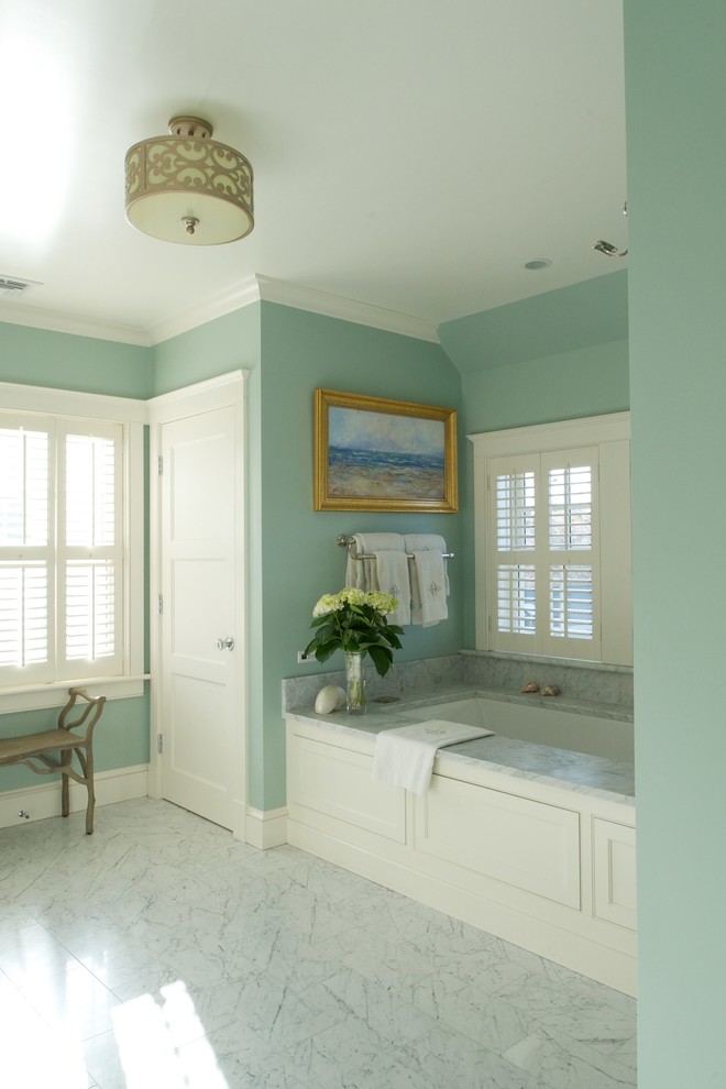 Traditional master bathroom in Boston with furniture-like cabinets, white cabinets, marble benchtops, an undermount tub, stone tile, blue walls and marble floors.