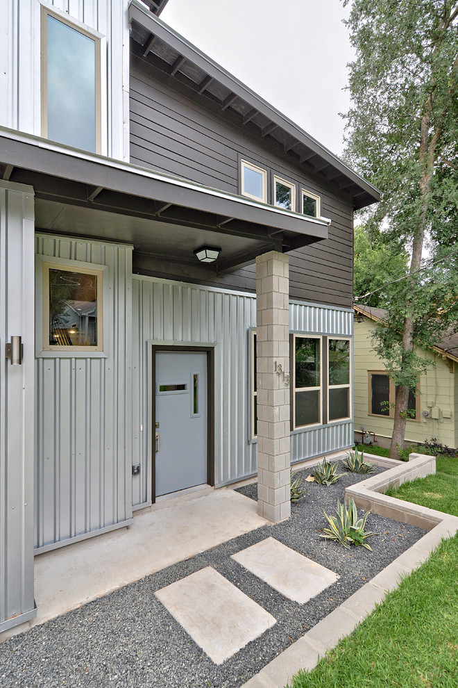 This is an example of a contemporary entryway in Austin with a gray front door.