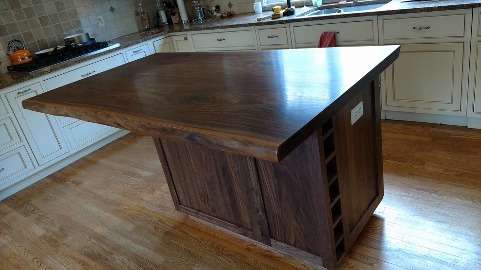 Walnut and mid-sized mountain style l-shaped medium tone wood floor and brown floor open concept kitchen photo in DC Metro with wine storage, an undermount sink, beaded inset cabinets, dark wood cabinets, wood countertops, beige backsplash, ceramic backsplash, stainless steel appliances and an island