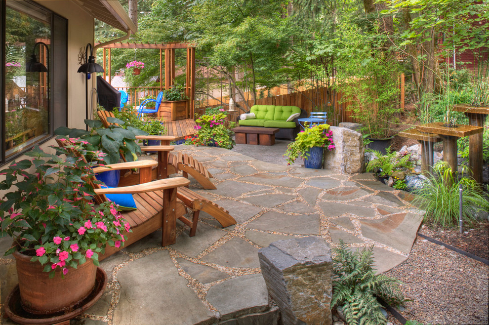This is an example of a country backyard patio in Portland with natural stone pavers.