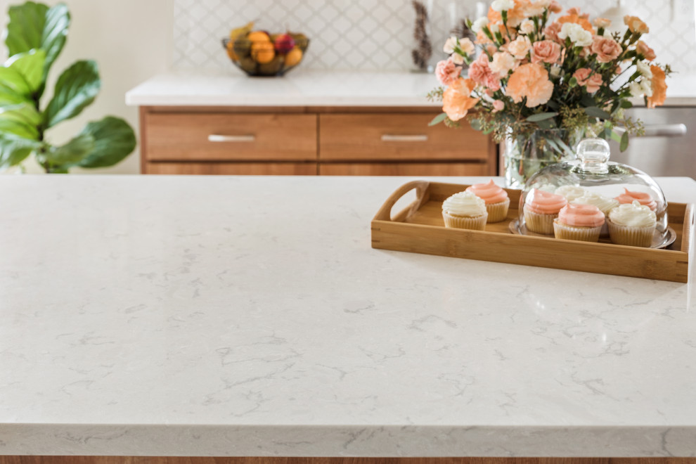 Example of a large transitional l-shaped cement tile floor and white floor eat-in kitchen design in Philadelphia with a single-bowl sink, flat-panel cabinets, medium tone wood cabinets, quartzite countertops, white backsplash, ceramic backsplash, stainless steel appliances, an island and white countertops