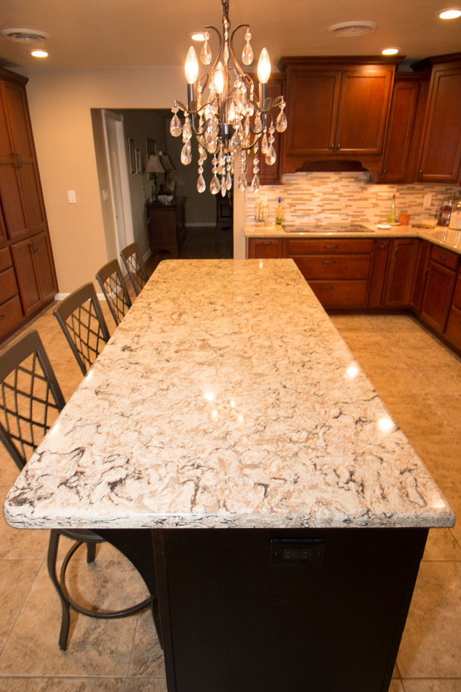 Large transitional u-shaped porcelain tile kitchen photo with an undermount sink, flat-panel cabinets, medium tone wood cabinets, quartz countertops, beige backsplash, mosaic tile backsplash, stainless steel appliances and an island