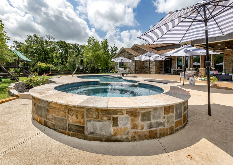Example of a mid-sized backyard custom-shaped natural pool design with decking