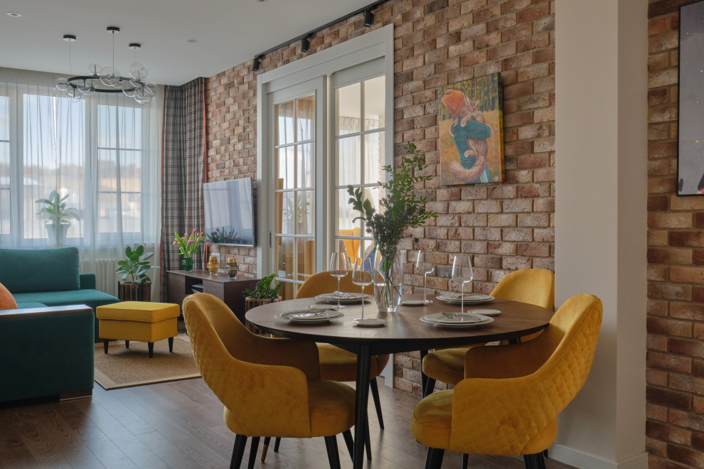 Photo of a mid-sized industrial open plan dining in Moscow with beige walls, dark hardwood floors, brown floor and brick walls.