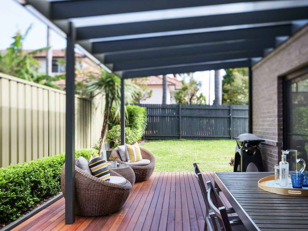 Inspiration for a traditional backyard deck in Sunshine Coast with a pergola.