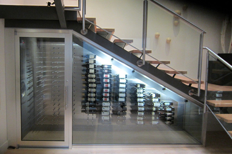 Photo of a mid-sized modern wine cellar in Sacramento with porcelain floors, display racks and beige floor.