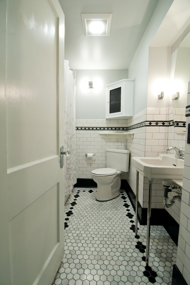 Inspiration for a small traditional 3/4 bathroom in Cincinnati with an alcove tub, a shower/bathtub combo, a two-piece toilet, white tile, subway tile, grey walls, a console sink, grey floor and a shower curtain.