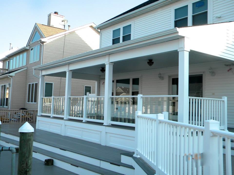 Deck - large transitional backyard deck idea in New York with an awning