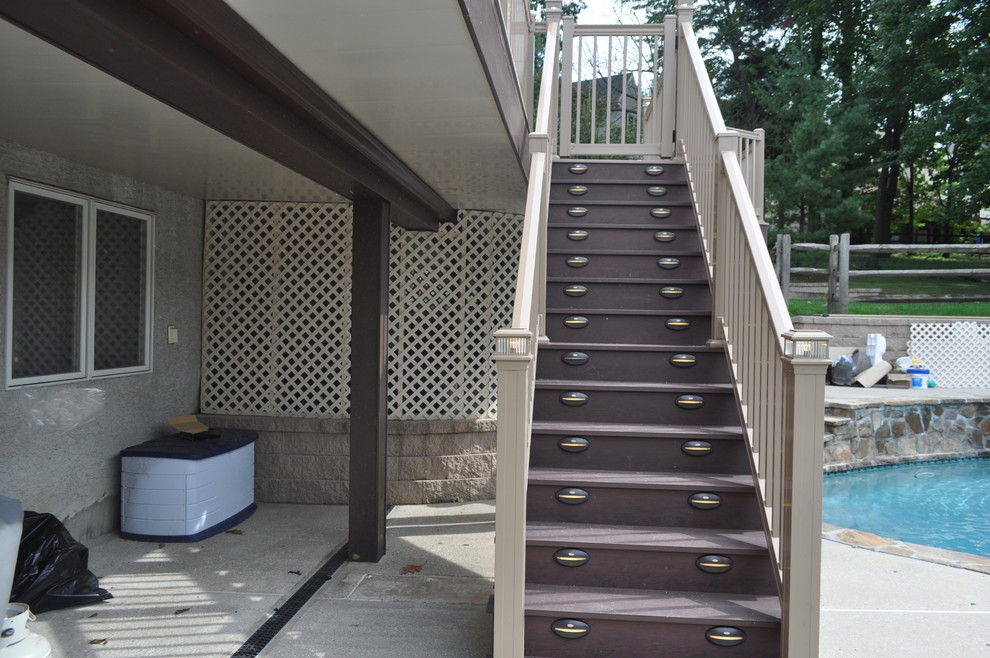 Inspiration for a mid-sized transitional backyard deck remodel with no cover