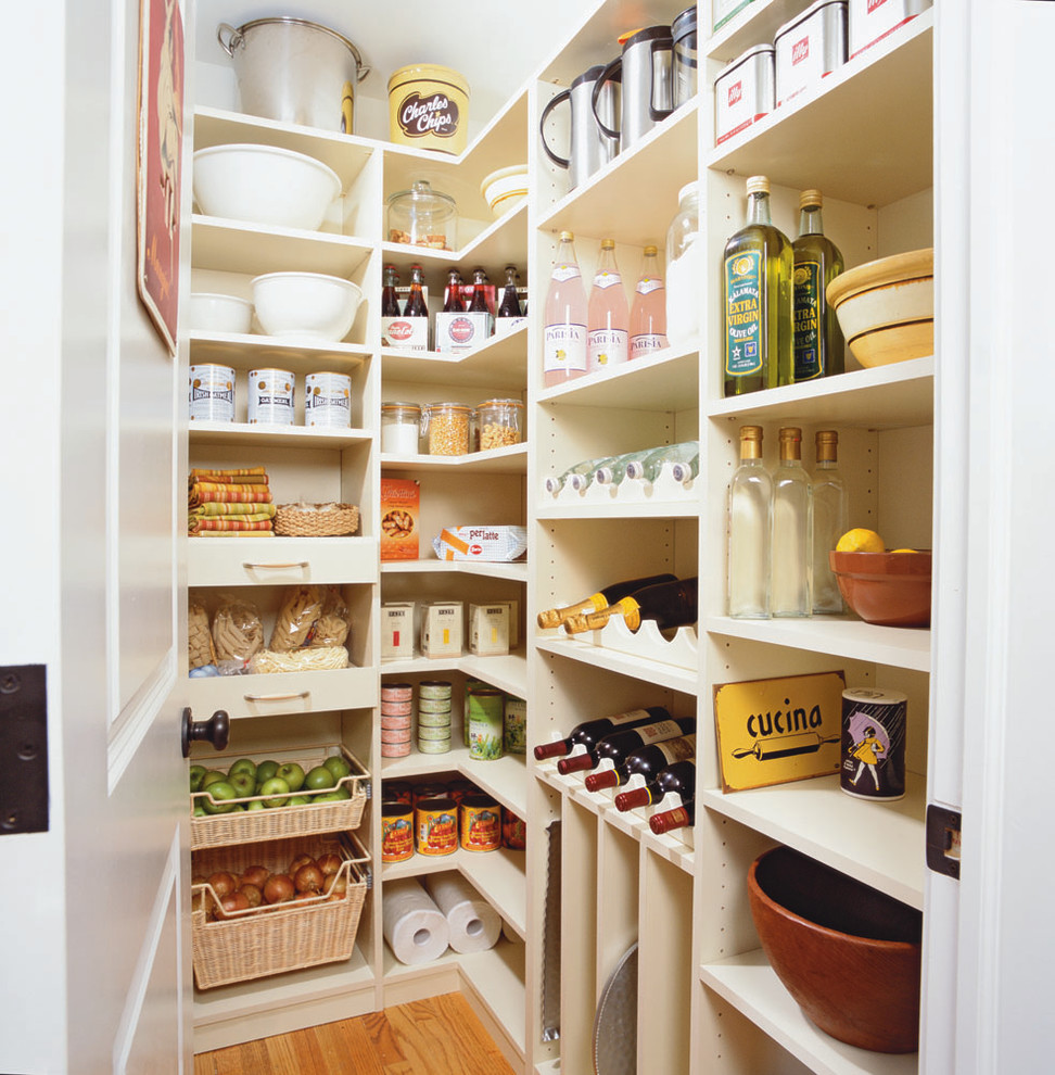 Inspiration for a large traditional l-shaped kitchen pantry in New York with open cabinets, white cabinets, light hardwood floors and beige floor.