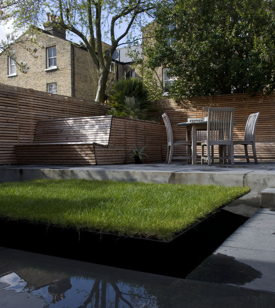Design ideas for a contemporary patio in London with a water feature.