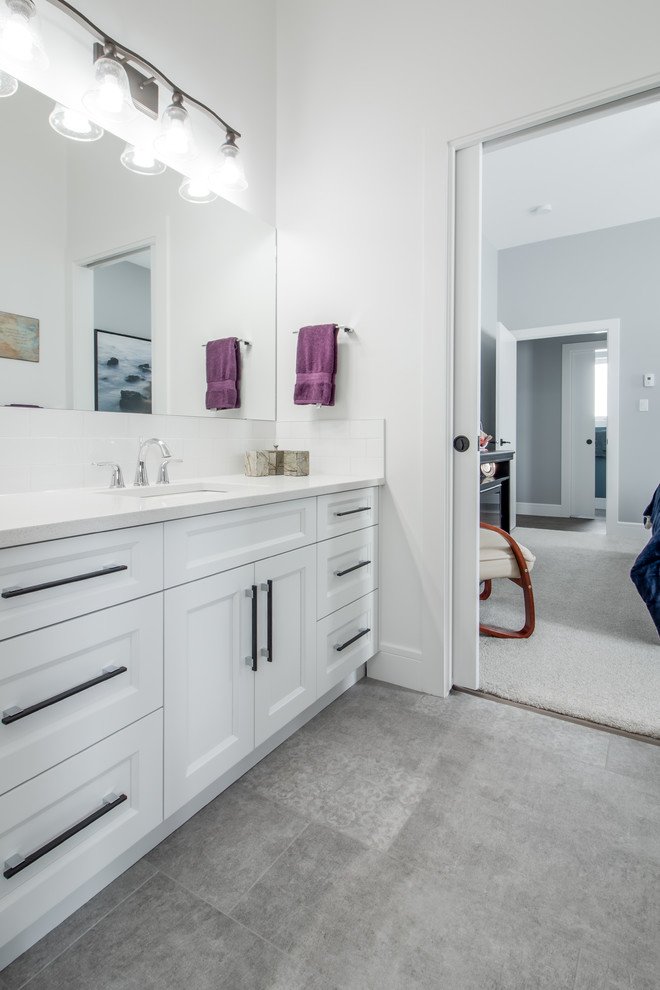 Design ideas for a small transitional 3/4 bathroom in Calgary with shaker cabinets, white cabinets, an alcove tub, a shower/bathtub combo, a two-piece toilet, white tile, subway tile, white walls, ceramic floors, an undermount sink and quartzite benchtops.
