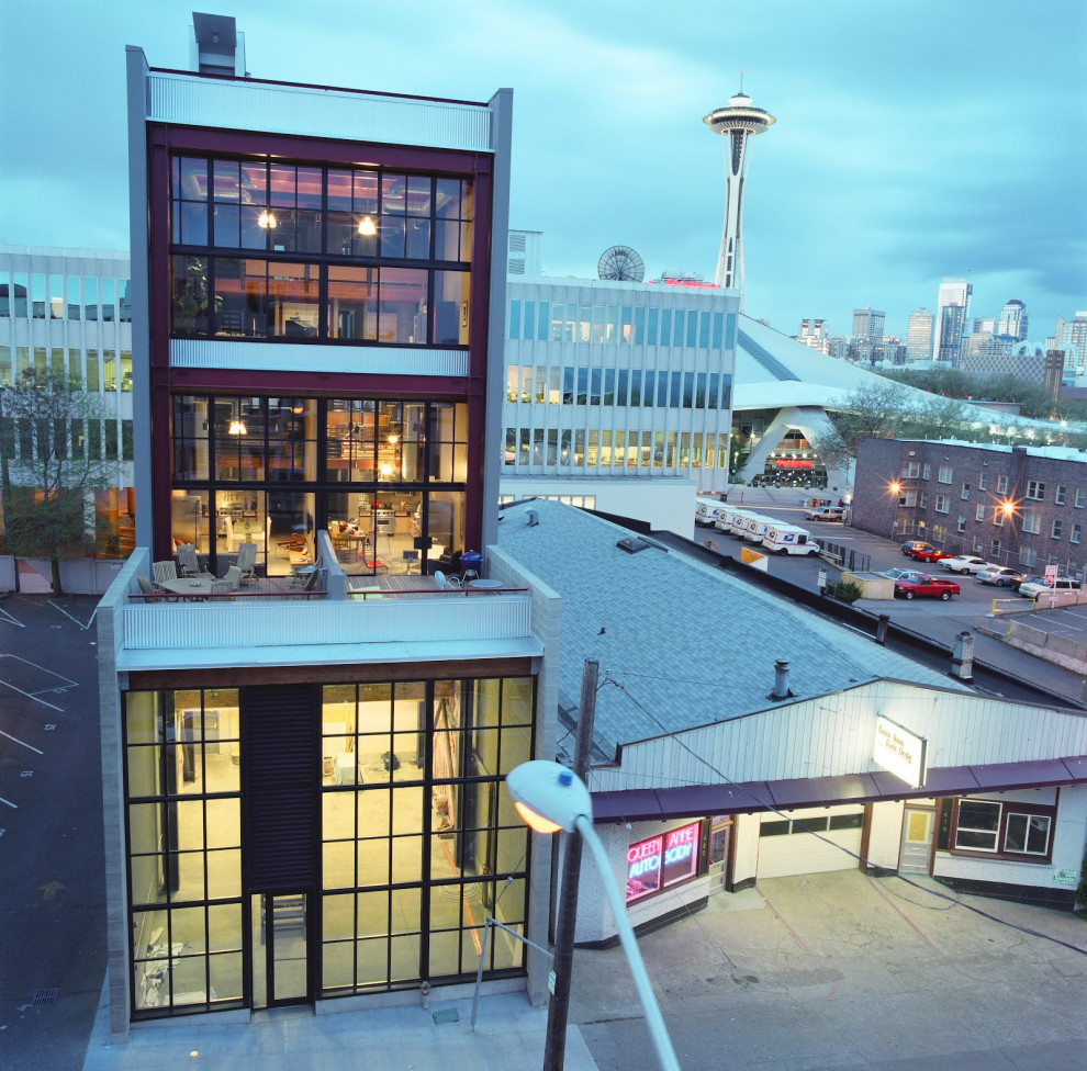 Photo of a large industrial grey house exterior in Seattle with four or more storeys, metal siding and a flat roof.
