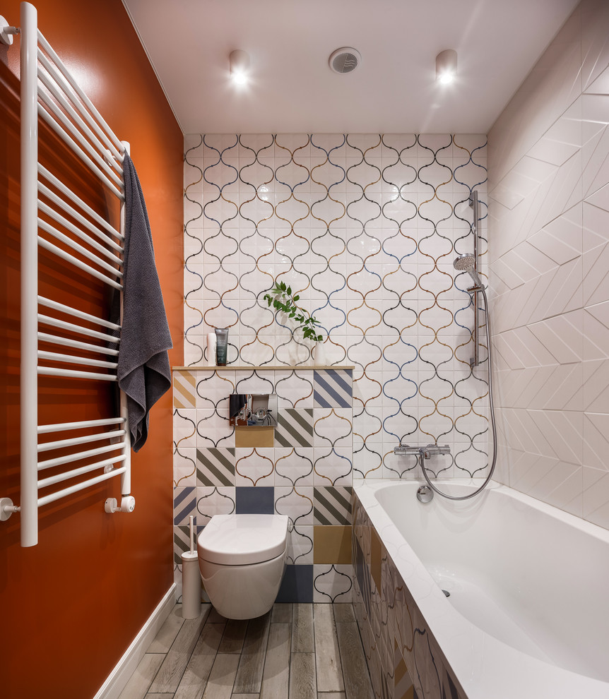 Inspiration for a contemporary bathroom in Other with a wall-mount toilet, orange walls and grey floor.