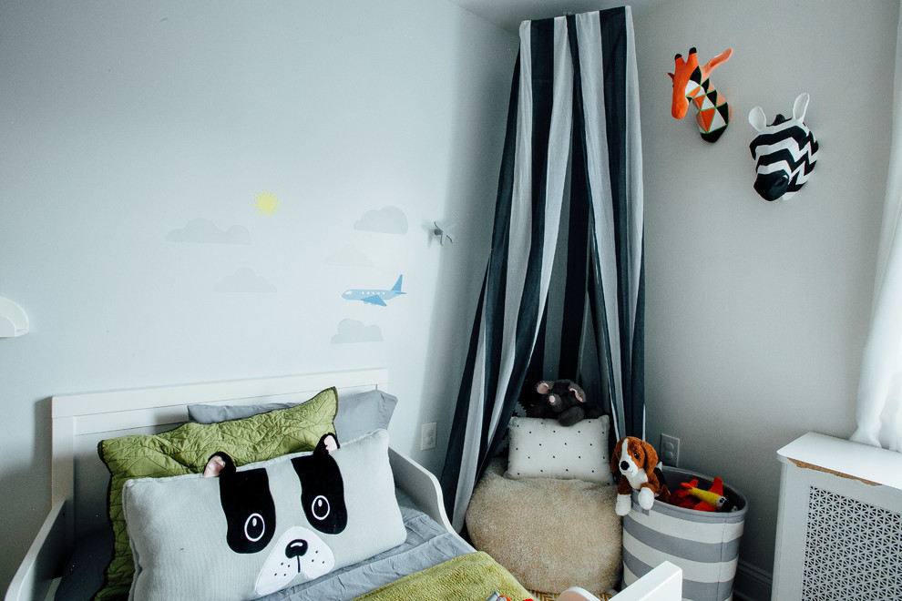 This is an example of a small contemporary kids' room for boys in New York with grey walls, dark hardwood floors and brown floor.