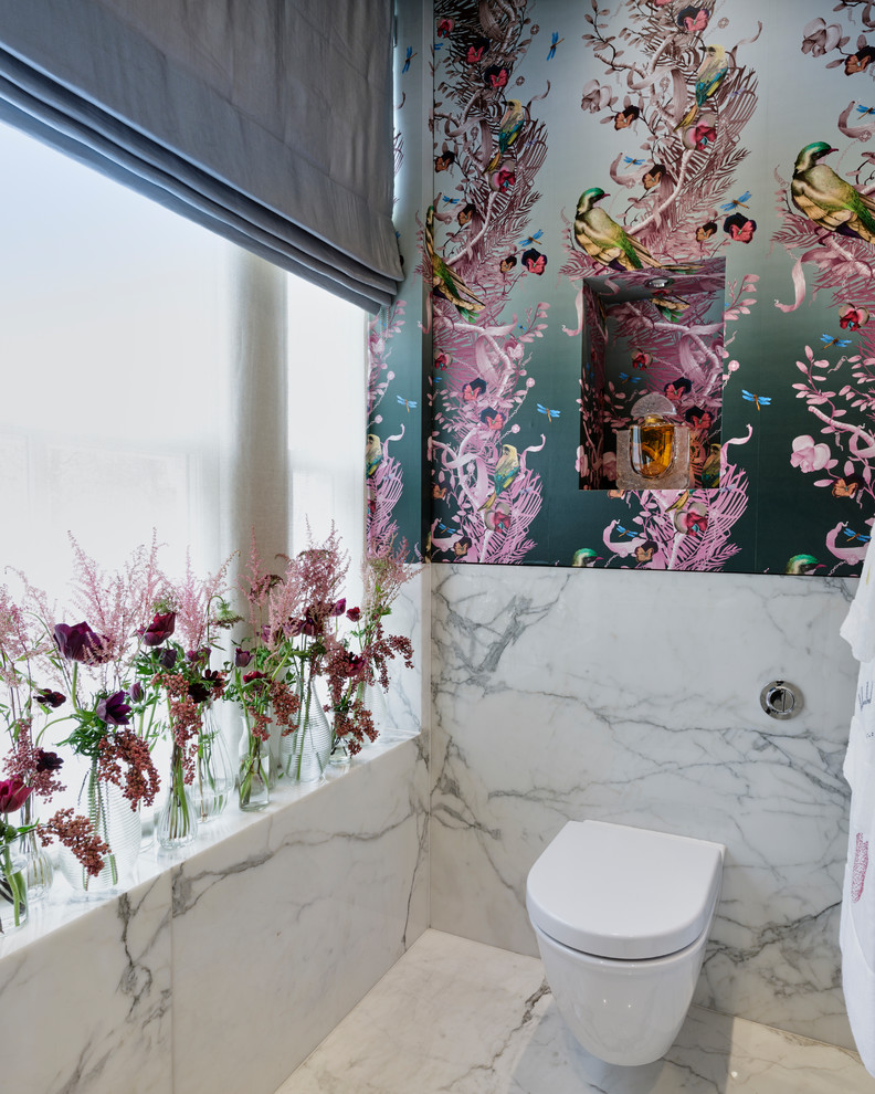 This is an example of a small asian powder room in London with multi-coloured walls, marble floors, white floor, a one-piece toilet and marble.
