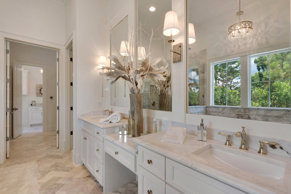 This is an example of a large country bathroom in Other with recessed-panel cabinets, white cabinets, a freestanding tub, a one-piece toilet, multi-coloured tile, mosaic tile, white walls, marble floors, an undermount sink, marble benchtops and with a sauna.