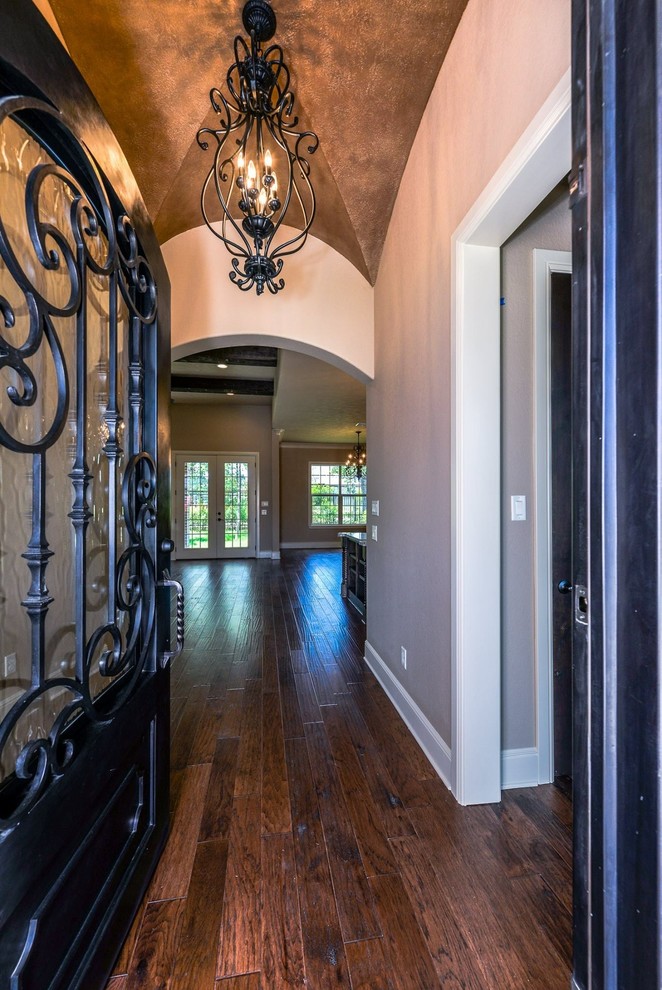 Foyer - large rustic dark wood floor foyer idea in Austin with beige walls and a black front door