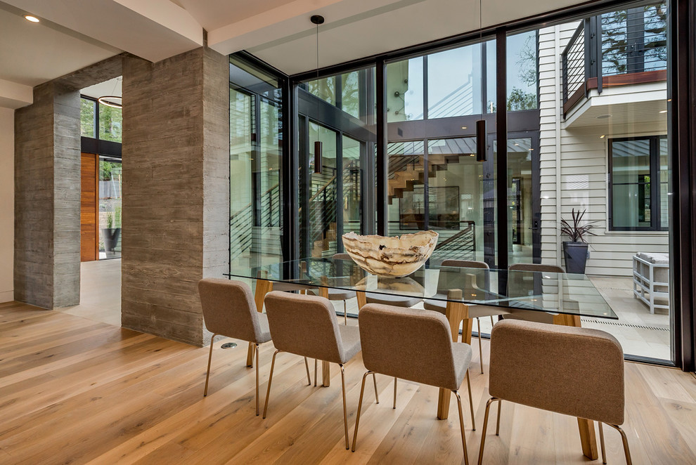 This is an example of a contemporary dining room in San Francisco with light hardwood floors.