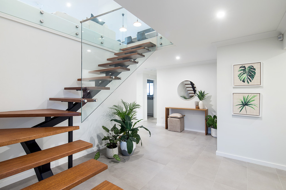 Photo of a mid-sized contemporary wood l-shaped staircase in Sydney with open risers.