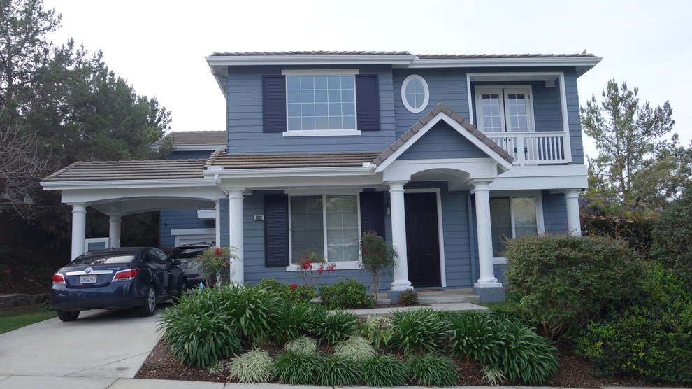 Inspiration for an expansive traditional two-storey blue exterior in San Diego with mixed siding.