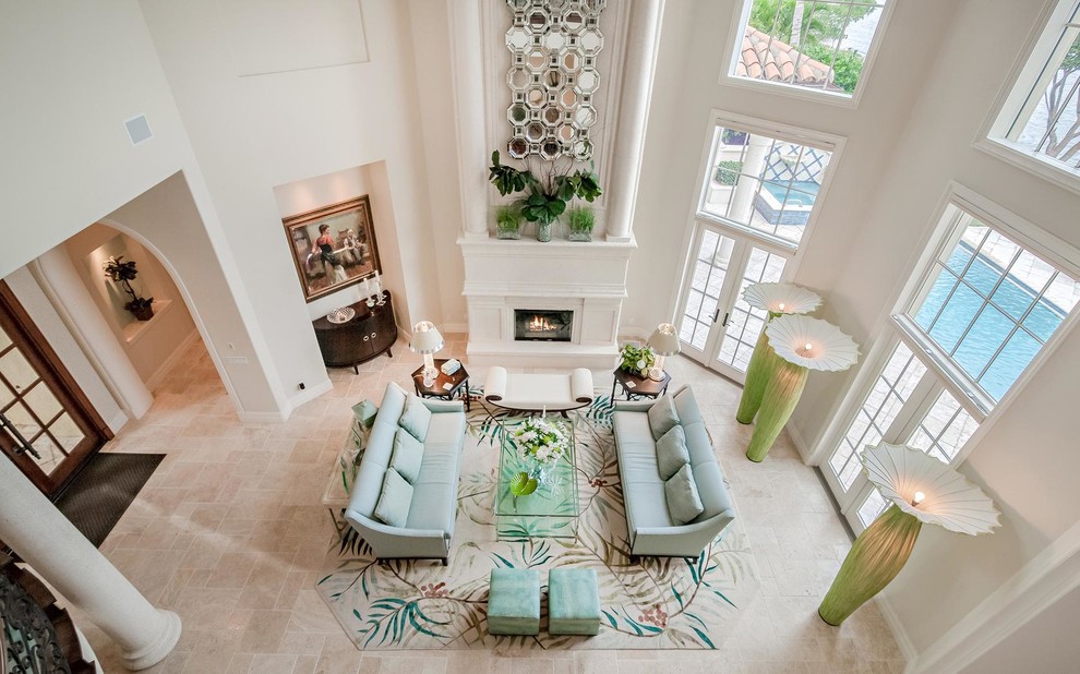 Inspiration for a large eclectic formal living room in Miami with white walls, limestone floors, a standard fireplace and a stone fireplace surround.
