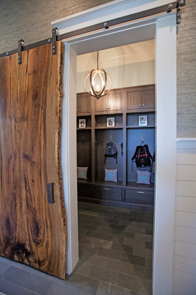 Design ideas for a large country mudroom in Atlanta with grey walls, slate floors and a dark wood front door.