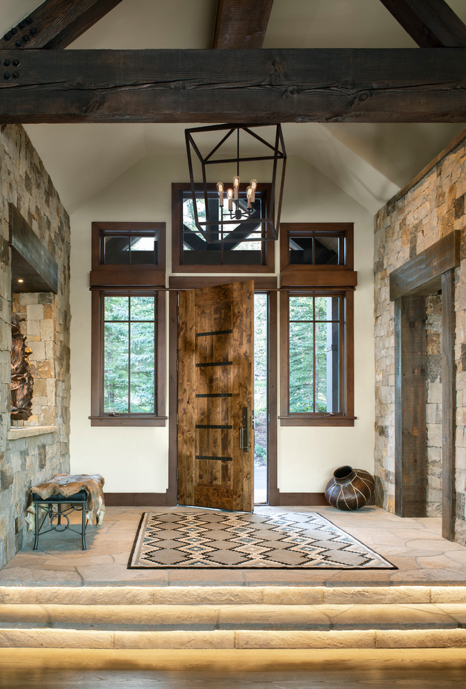Inspiration for a country foyer in Other with white walls, a single front door and a dark wood front door.