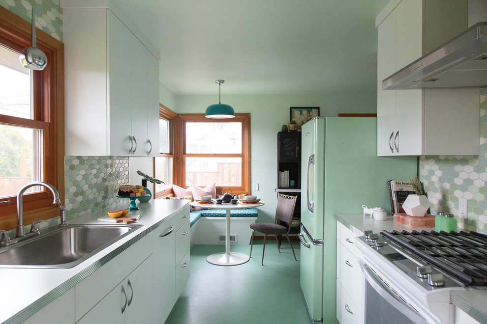 Design ideas for a small midcentury galley eat-in kitchen in Portland with a drop-in sink, flat-panel cabinets, white cabinets, laminate benchtops, multi-coloured splashback, ceramic splashback, coloured appliances, linoleum floors, no island, green floor and white benchtop.