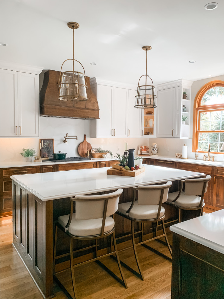 Kitchen - light wood floor kitchen idea with a double-bowl sink, shaker cabinets, white cabinets, quartz countertops, quartz backsplash, paneled appliances and an island