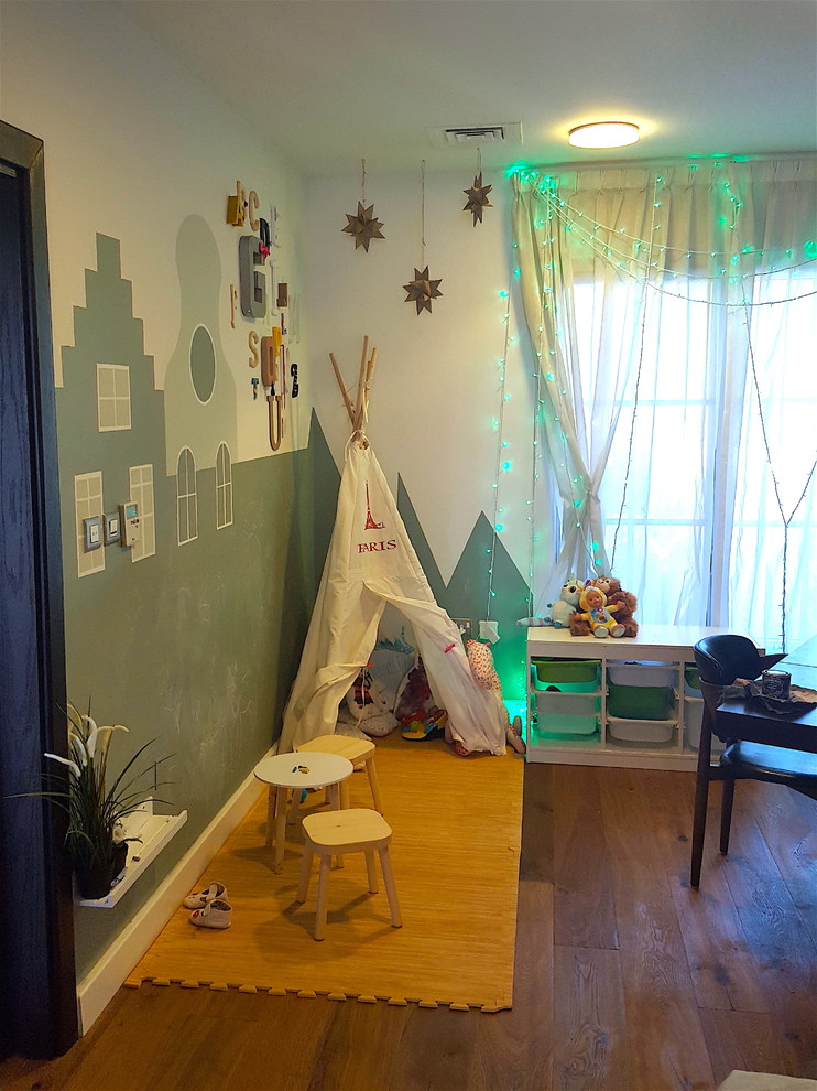 Design ideas for a small modern gender-neutral kids' room in Other with green walls.